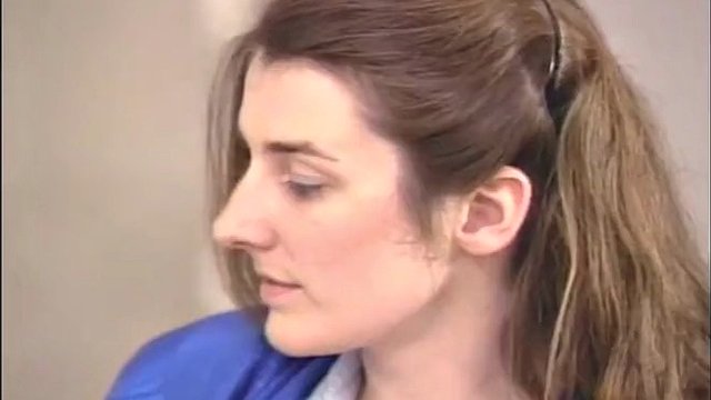 Eldre kvinne hjelper yngre kvinne med å melke de slappe puppene