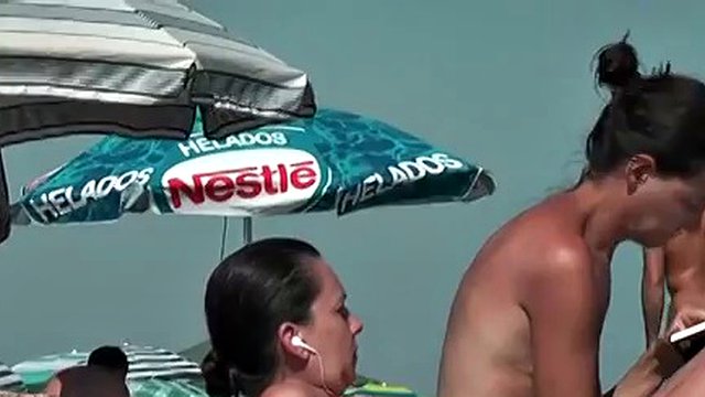 Bitch on the beach wetting her horny nudist pussy
