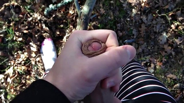 cute teen boy in his pajamas in the woods jerking
