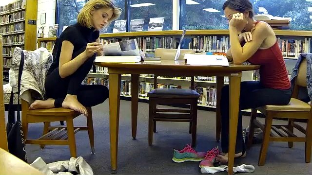 Shoe and sock removal for two women