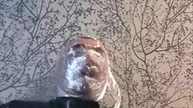 Breathing play with cling film in latex catsuit