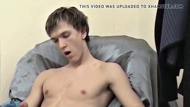 Handsome young man spunks up his belly during jerk off