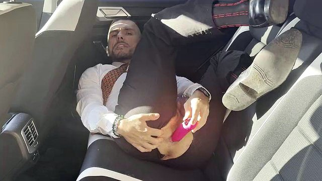 Kinky gentleman slave spread legs and plays with his ass in a car in public