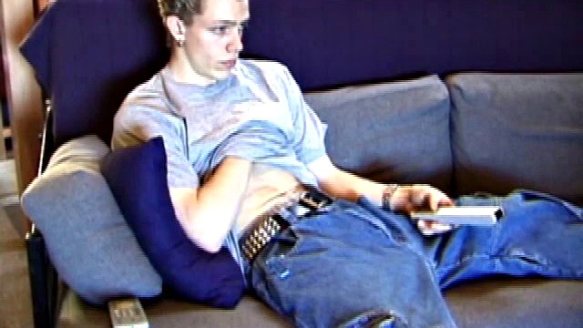 Shane relaxes on the sofa, while watching a porn video and becomes totally himself. He works his lubricated cock with determination and pumps a big load of cum on his shirt.